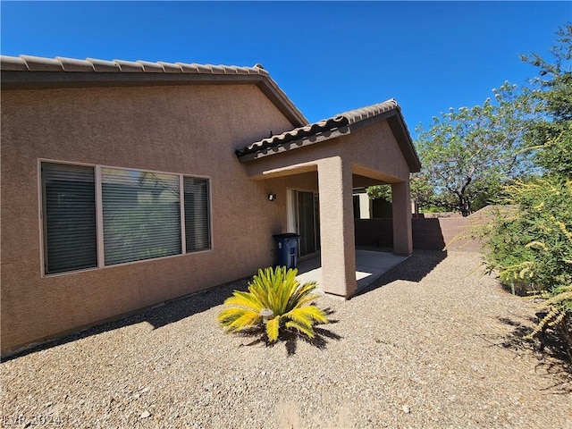 view of side of property featuring a patio area