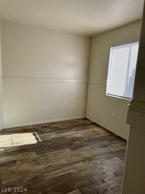 spare room featuring dark hardwood / wood-style floors