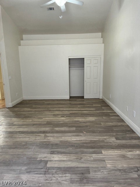 interior space featuring dark hardwood / wood-style flooring, a closet, and ceiling fan