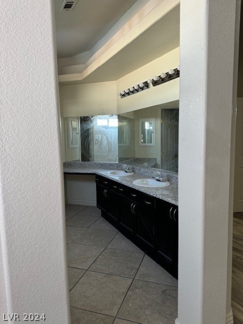 bathroom featuring tile patterned flooring and double sink vanity