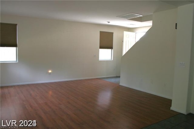 empty room featuring dark wood-type flooring