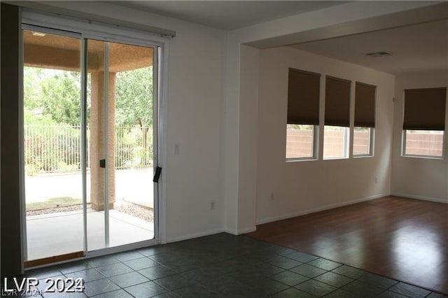 tiled spare room with a healthy amount of sunlight