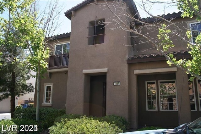 back of house with a balcony