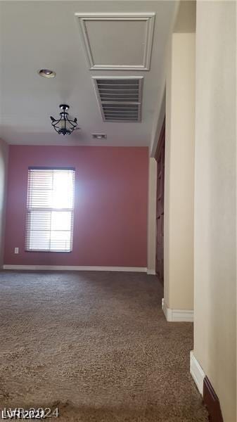 unfurnished room with dark colored carpet