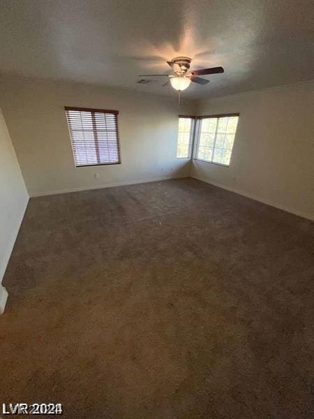 carpeted spare room with ceiling fan