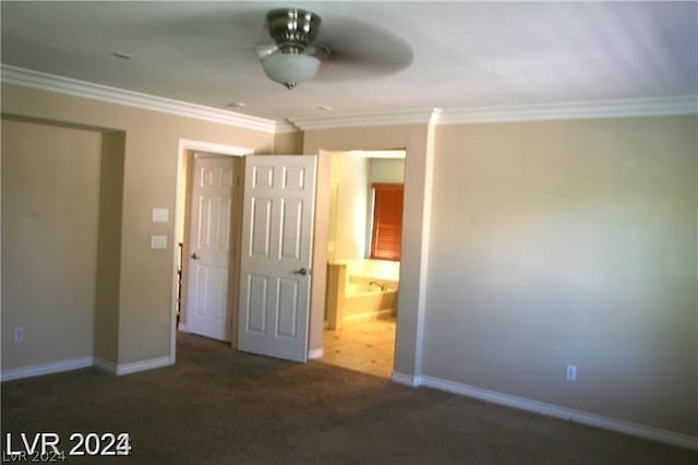 unfurnished bedroom with ceiling fan, dark carpet, and crown molding