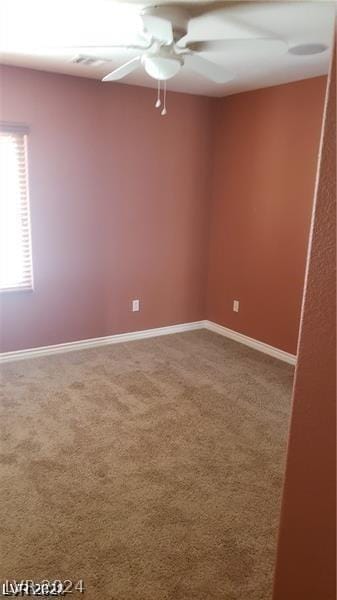 empty room featuring carpet floors and ceiling fan