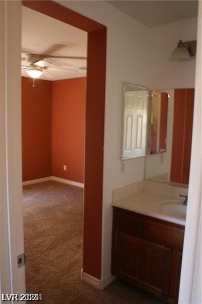 bathroom with ceiling fan and vanity