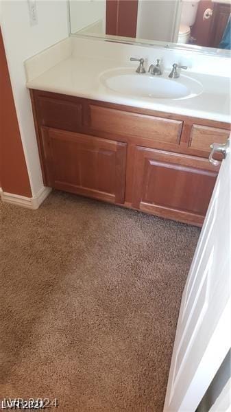 bathroom with toilet and vanity