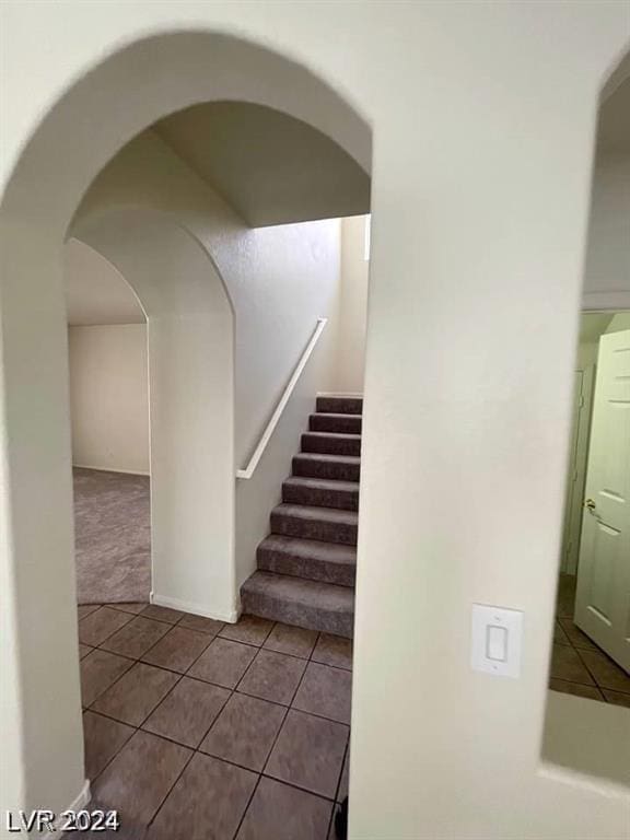 staircase featuring tile patterned floors