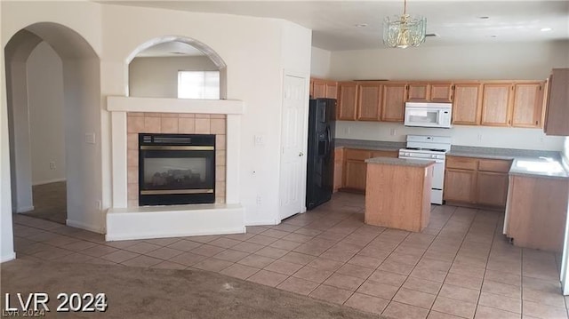 kitchen with light carpet, white appliances, a fireplace, pendant lighting, and a center island