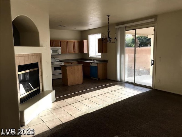 kitchen featuring an inviting chandelier, a center island, decorative light fixtures, stainless steel electric stove, and dishwashing machine