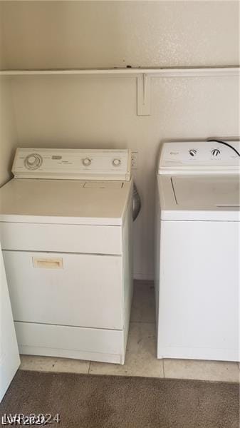 washroom featuring tile patterned floors and washer and clothes dryer