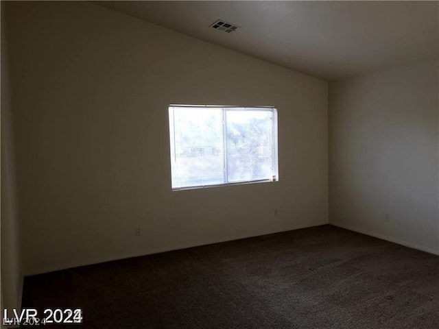 empty room with carpet and lofted ceiling