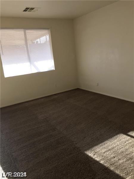 empty room with dark carpet