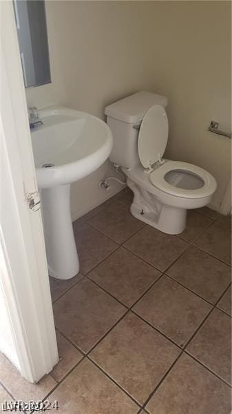 bathroom featuring toilet and tile patterned floors