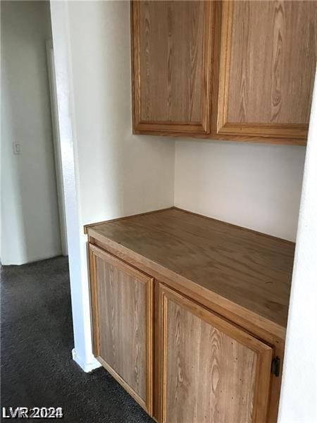 unfurnished office with dark colored carpet