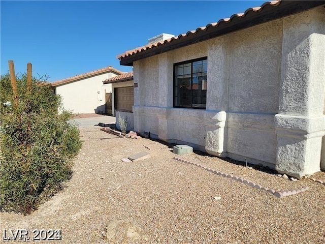 view of side of home with a garage