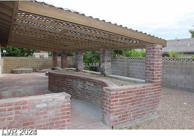 view of patio featuring a pergola and an outdoor bar