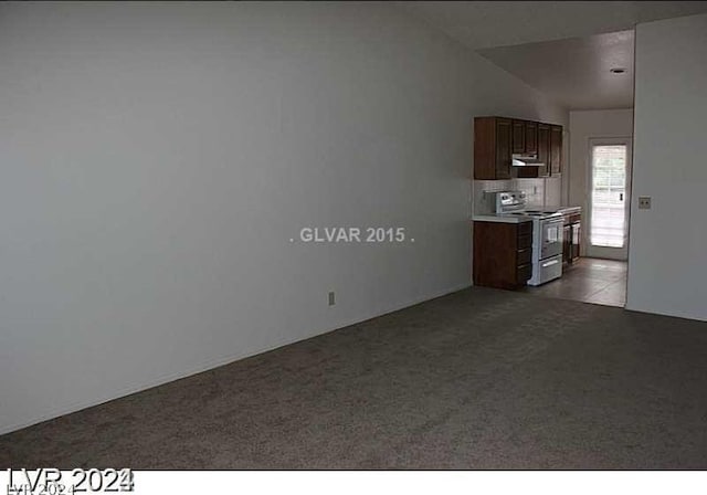 unfurnished living room with light carpet and lofted ceiling