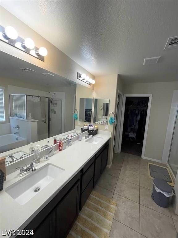 bathroom with vanity, tile patterned flooring, independent shower and bath, and a textured ceiling