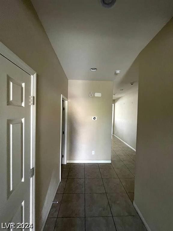 corridor with dark tile patterned flooring