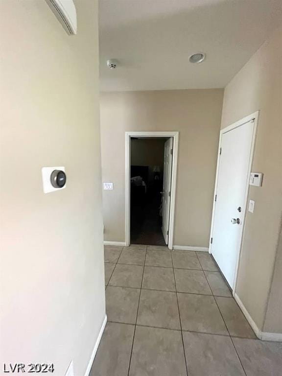 corridor with light tile patterned floors