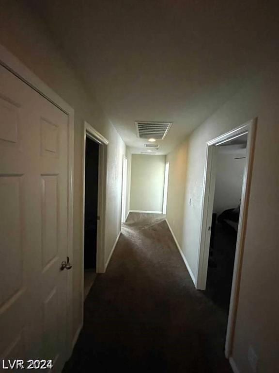 hallway with dark carpet