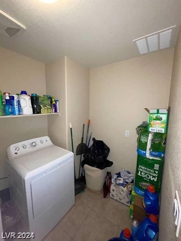 washroom featuring washer / dryer and tile patterned flooring