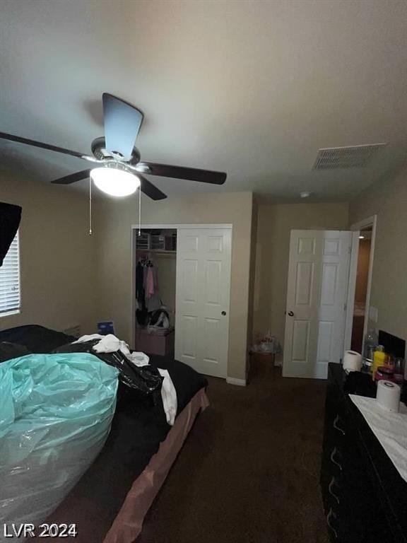 bedroom with ceiling fan and a closet