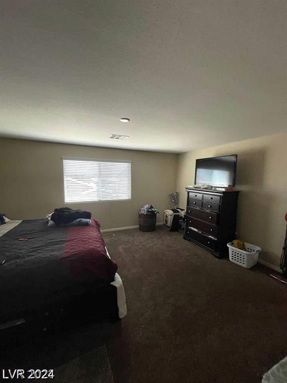 bedroom featuring dark colored carpet