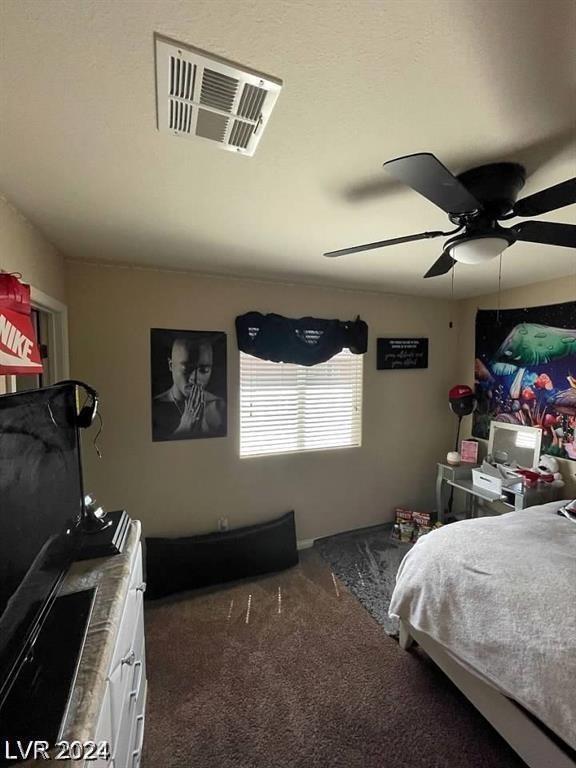 bedroom featuring ceiling fan and dark colored carpet