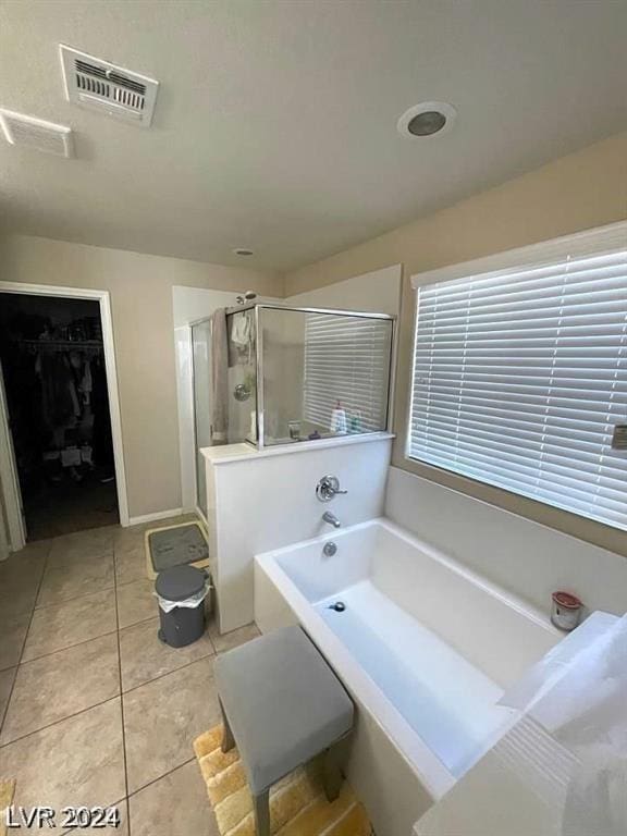 bathroom featuring tile patterned floors and plus walk in shower