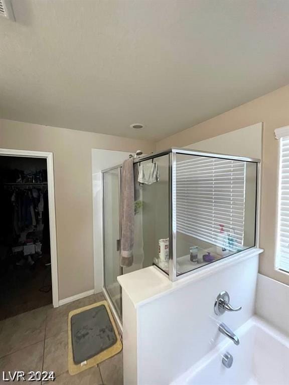 bathroom featuring separate shower and tub and tile patterned flooring