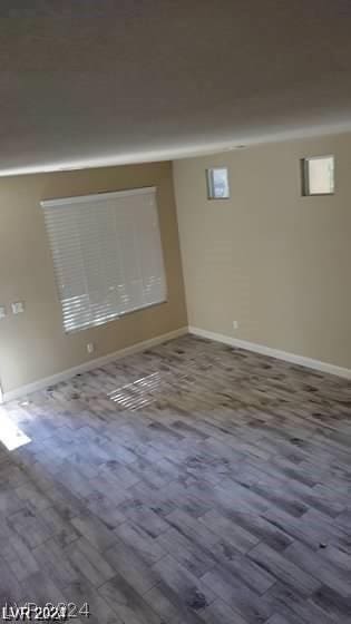 spare room with wood-type flooring