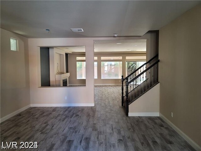 unfurnished living room featuring dark hardwood / wood-style flooring