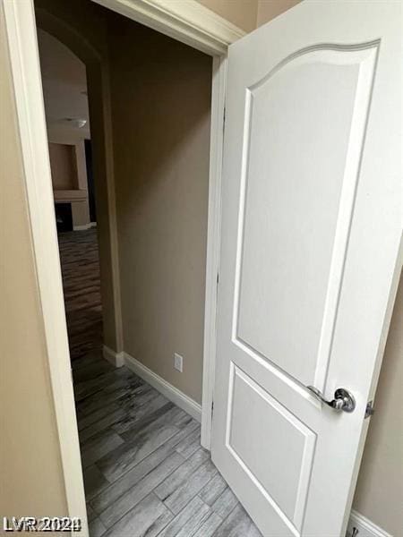 hallway with light hardwood / wood-style floors