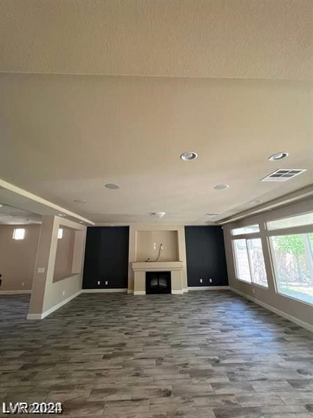 unfurnished living room with wood-type flooring