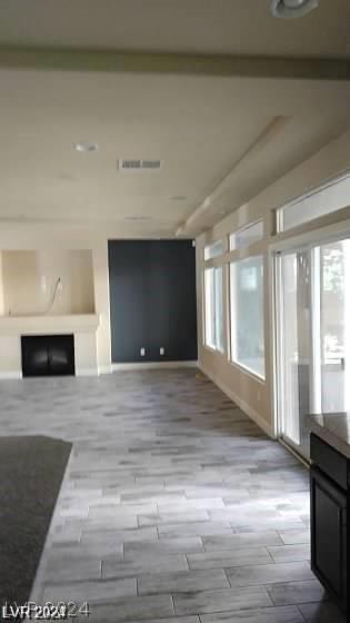 unfurnished living room with a wealth of natural light and light wood-type flooring