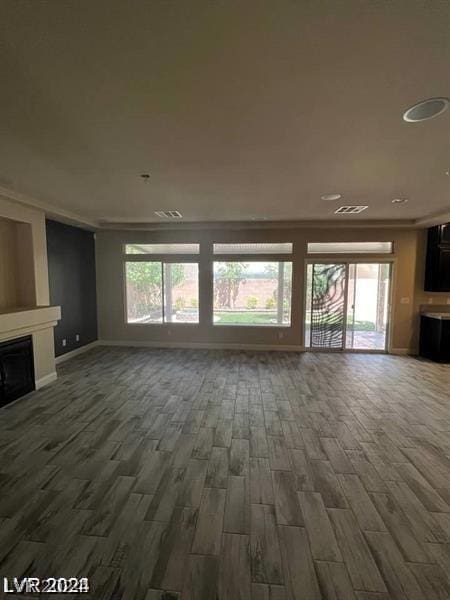 unfurnished living room with dark wood-type flooring