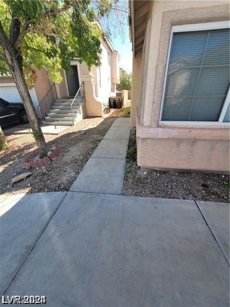 view of property exterior with a patio area