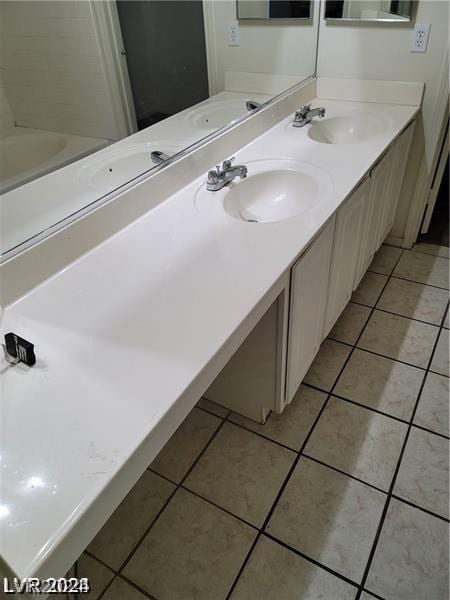 bathroom with vanity and tile patterned flooring