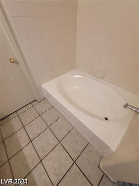 bathroom featuring a tub and tile patterned flooring