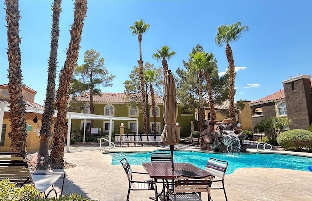 community pool with a patio and fence