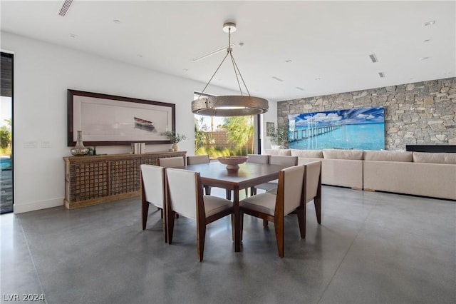 dining space featuring concrete floors