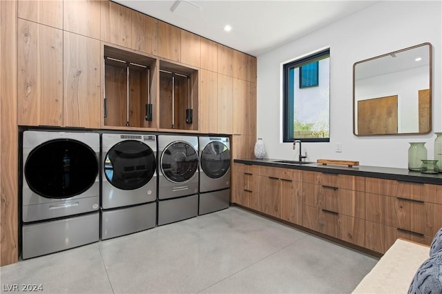 clothes washing area with sink and washer and dryer