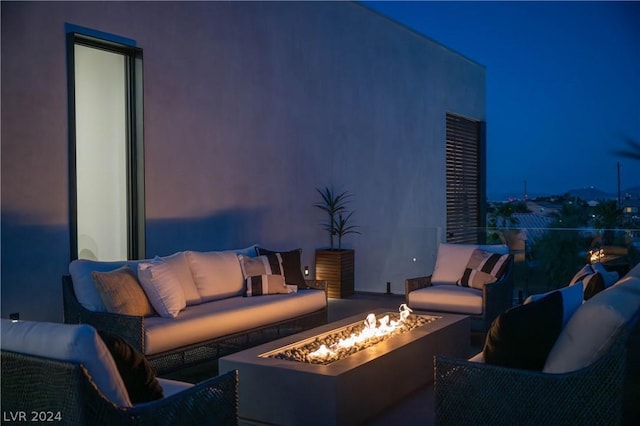 view of patio / terrace with an outdoor living space with a fire pit