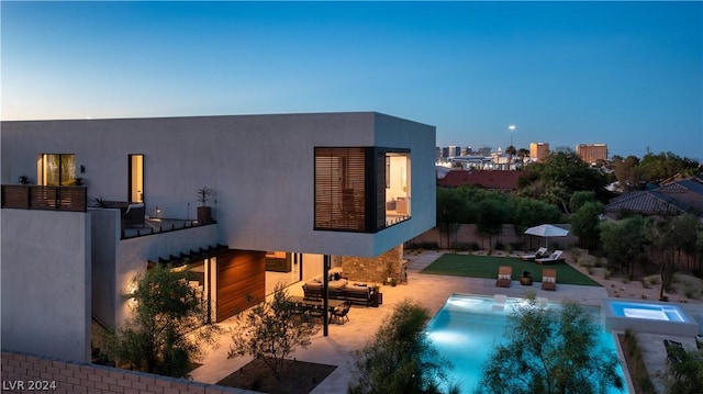 exterior space featuring a swimming pool with hot tub and a patio area