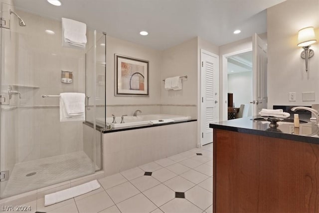 bathroom with tile patterned flooring, vanity, and independent shower and bath