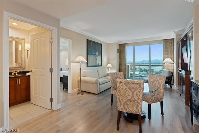 interior space featuring crown molding and light hardwood / wood-style floors